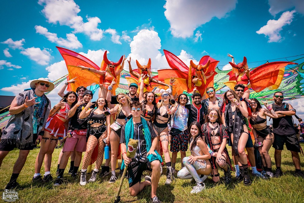 A group of festival-goers gather together to take a picture. 